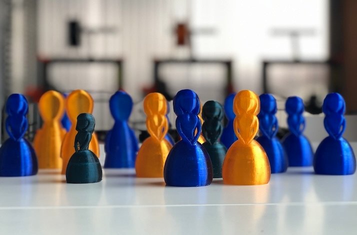3D printed board game figurines, designed in the shape of a female character.