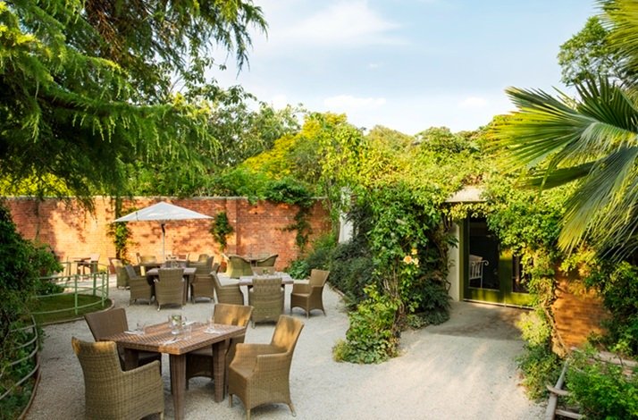 Inner yard with tables for guests at the on-site restaurant at Mount Usher Gardens.