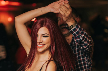 A couple dancing salsa in a vibrant Salsa club in Miami