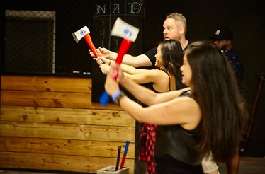 Participants learning how to throw axes at the target.