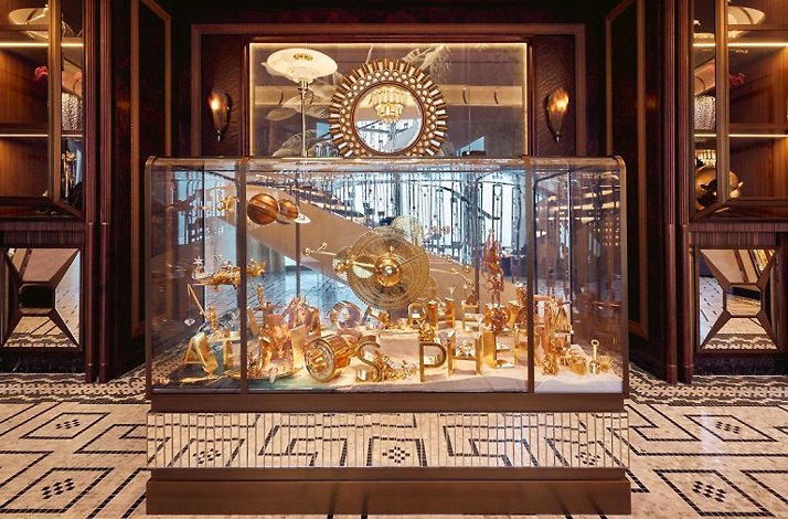 Golden figures in a glass display at At.mosphere Burj Khalifa