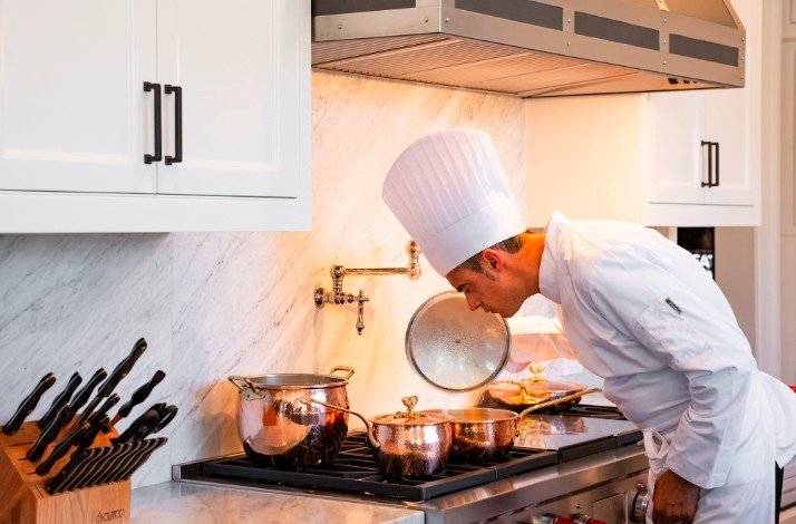 Chef Pasquale Martinelli in uniform cooking dinner.