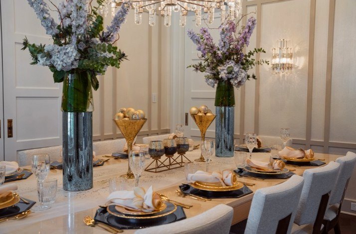 A dinner table for ten guests laid with two vases of flowers for nine-course Italian menu by Chef Pasquale Martinelli.