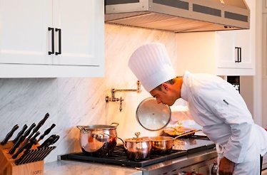 Chef Pasquale Martinelli in uniform cooking dinner.