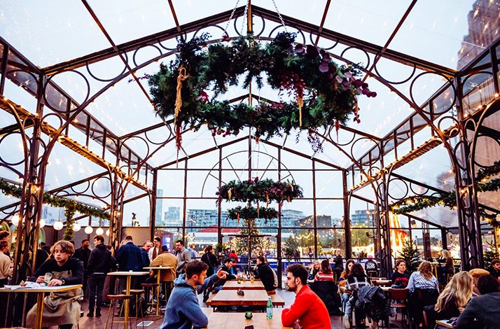 Glass house bar and dining area that is part of the festive setup at Battersea Power Station in London. 