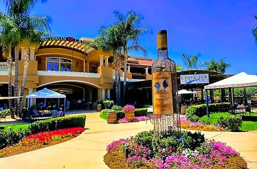 The building of the Wilson Creek Winery with a metal sculpture of a wine bottle out front.