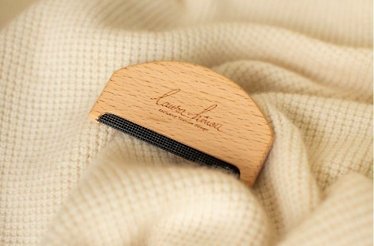 A branded wooden logo of Laura Hîncu.