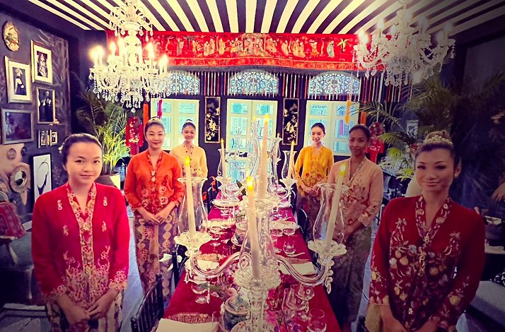 Little Social waitresses wearing traditional clothes are greeting guests