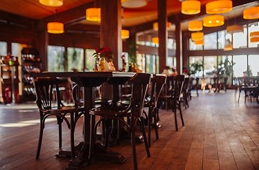 A view of the cozy restaurant KUIB featuring wooden tables and chairs at Sinaia, Moldova.