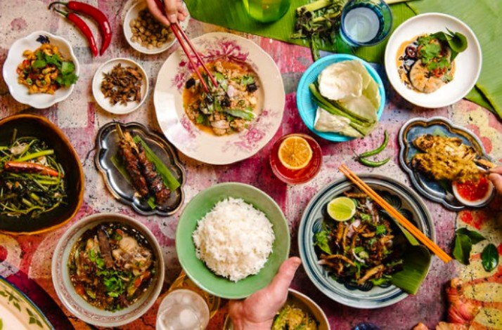 A table full of different plates of food, like rice or some typical foods from Thailand