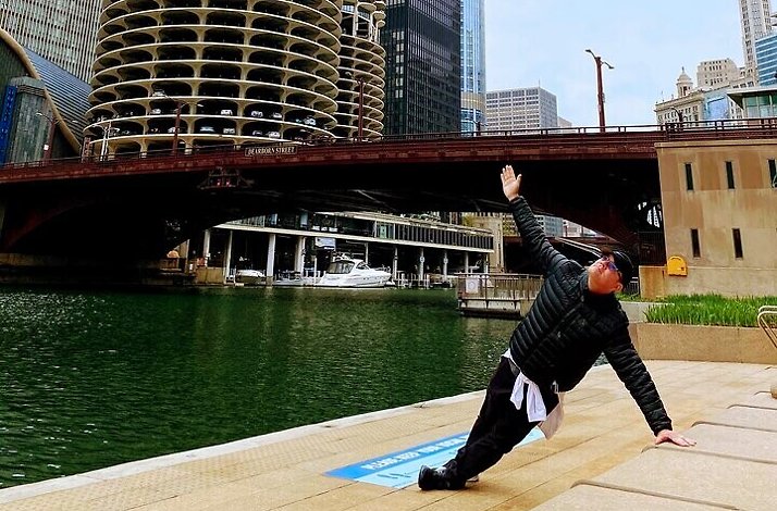 A participant of Chicago River Yoga Walk training beside the river