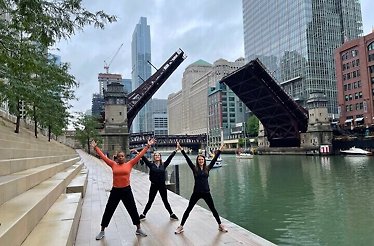 Participants of Chicago River Yoga Walk in front of Clark Street Bridge during the tour