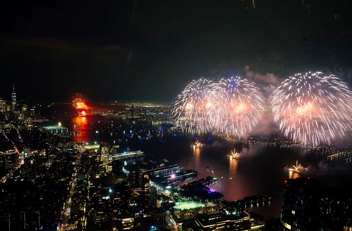 NYC skyline fireworks over Hudson River.