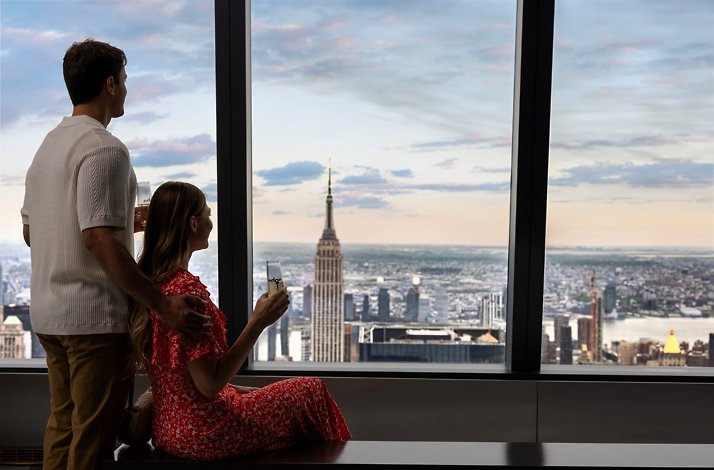 Sip champagne on the highest outdoor sky deck in the Western Hemisphere: In New York, New York The couple is enjoying views by the window