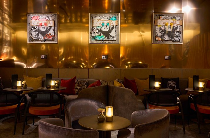 Cozy indoor of Quin Bar featuring warm lighting and artsy décor.