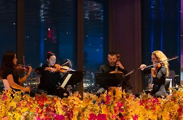 String quartet on candle‑lit stage at night
