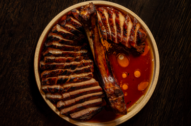 A premium grilled meat dish with rich sauce from Southeast Asian grill Ashe, Sydney.