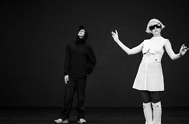 Promotional black and white poster for TOMORA.