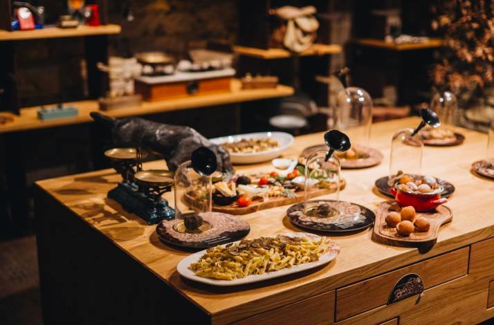 A table set with a lot of different plates with different kinds of snacks