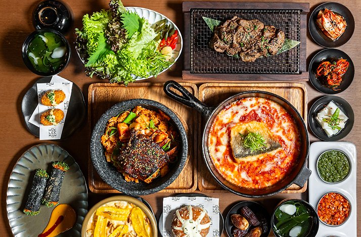 A dinner table with dishes from Ramadan set menu consisting of Middle Eastern and Korean fusion cuisine.