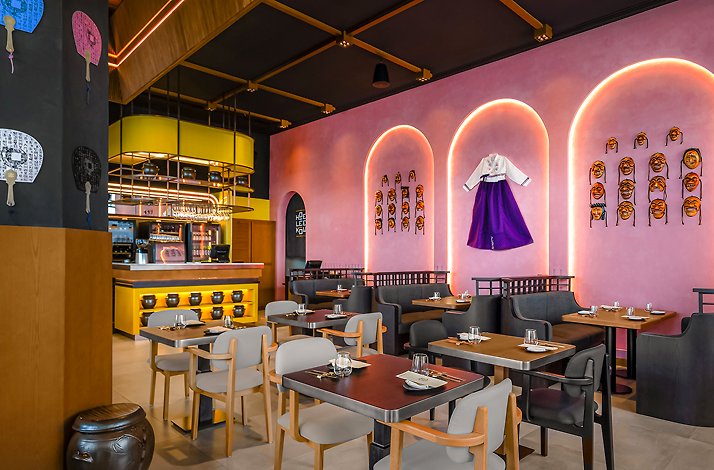 Dining area of Hoe Lee Kow with pink walls and decorations.