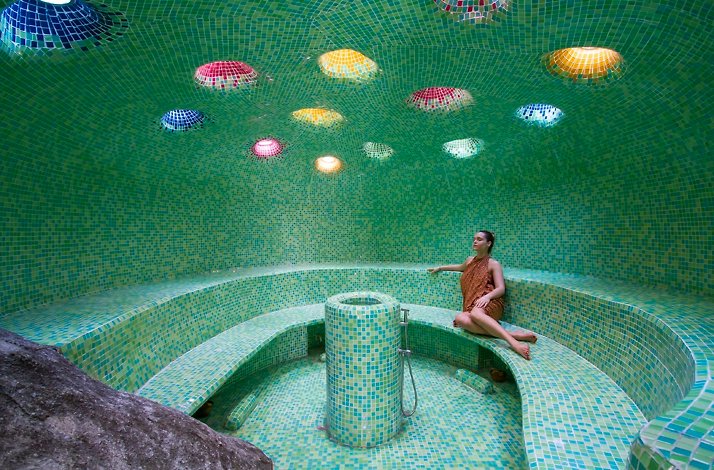 Guest sitting at sauna at Kamalaya Koh Samui Wellness Sanctuary & Holistic Spa.