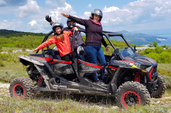 Woman with two kids on a quad bike during quad safari tour in Istria, Croatia.