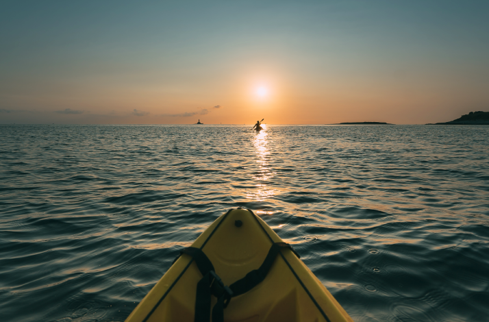 Kayak point of view in Medulin Bay during sunset.