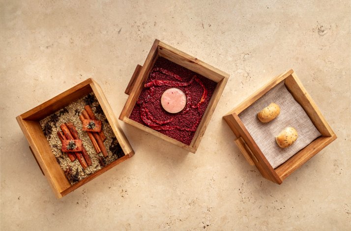 Set of wooden boxes with stylish snacks and sauces served in Gēn restaurant, in Georgetown
