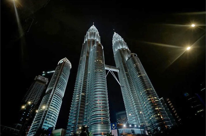 Kuala Lumpur skyscrapers at night, captured from the below during the guided vespa tour.