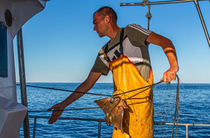 A fisherman on a boat.