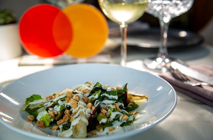 A freshly made salad served in art deco restaurant Arango in Mexico city. Table is decorated with Mastercard logo