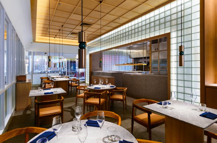 Dining area with open kitchen at Gēn restaurant in George Town, Malaysia.