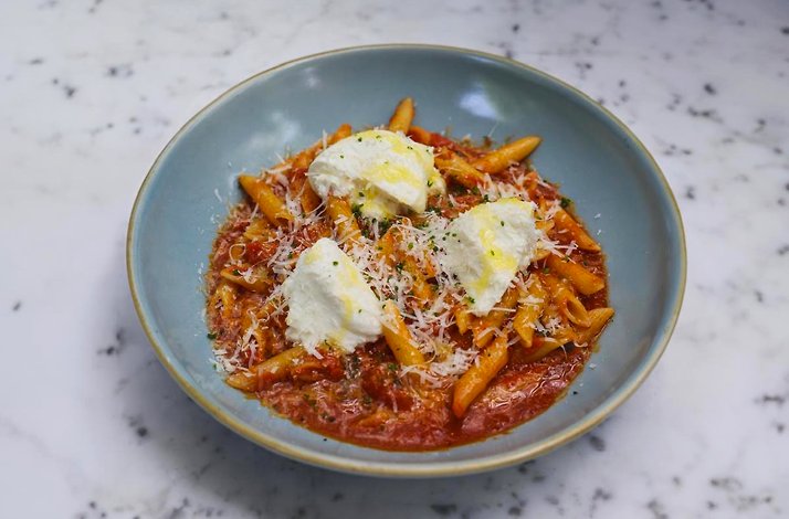 A freshly prepared pasta dish with chees served in a blue plate at Mexico City's Casa Ó restaurant