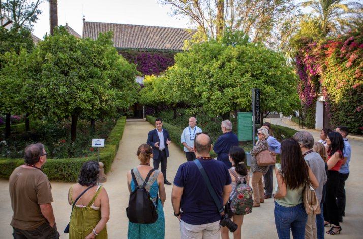 Visit Seville's Palacio de Las Dueñas with exclusive upper-floor access: In Seville, Spain The tour guide of Palacio de Las Dueñas telling the history of the place to group of tourists