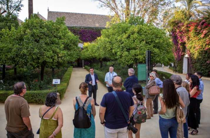 The tour guide of Palacio de Las Dueñas telling the history of the place to group of tourists