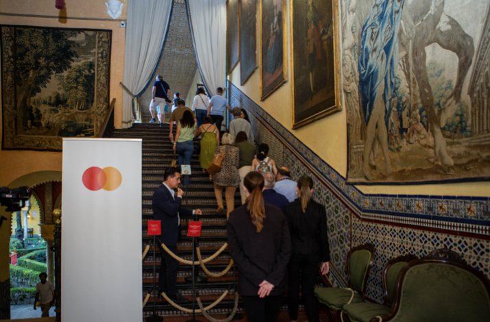 The tourists next to Mastercard commercial sign going up the stairs 