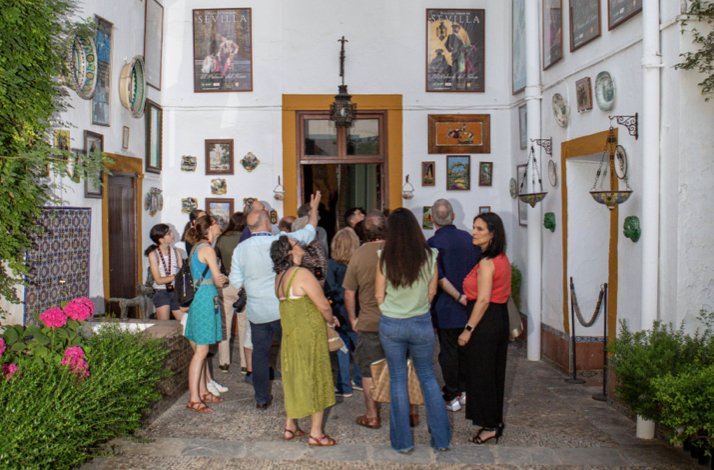 Group of tourists standing at the entrance of historical room at Palacio de Las Dueñas