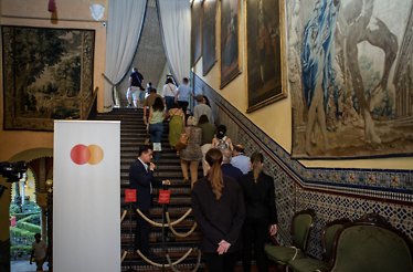The tourists next to Mastercard commercial sign going up the stairs 