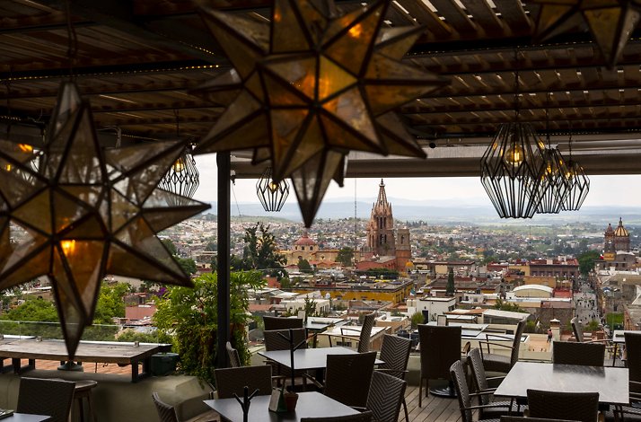 The elegant dining area of Antonia Rooftop restaurant decorated with dimming lamps of different shapes.