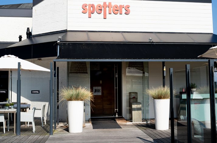 The entrance to Spetters Restaurant, which features the JRE logo on the door.