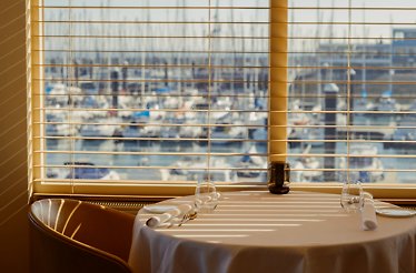 Table set for two at restaurant Spetters with marina view.
