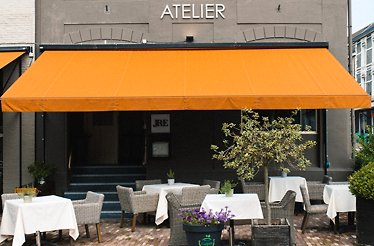 The entrance to Atelier Restaurant, which features the JRE logo.