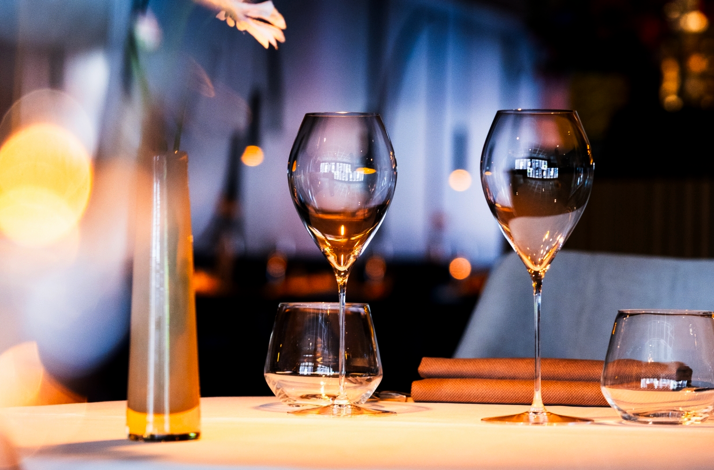 Table setting with wine glasses at Amused Food & Wine.