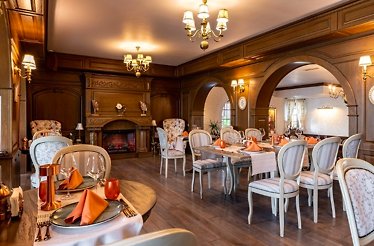 A view of the Restaurant Conac with vintage interior and white wooden chairs