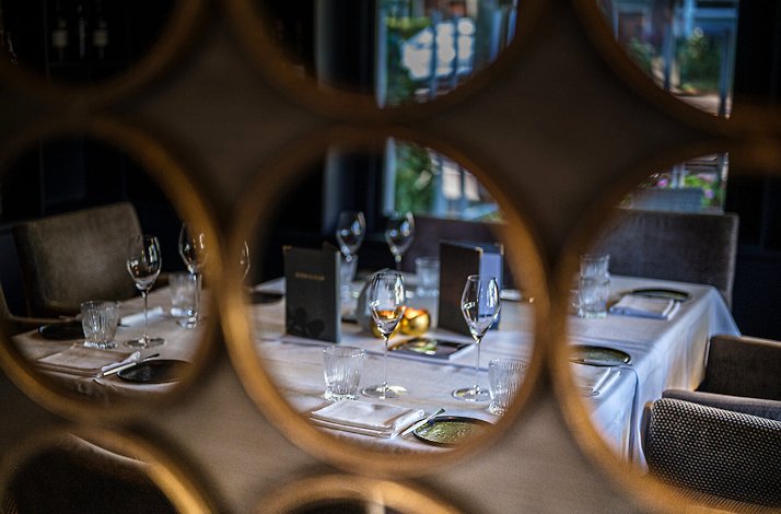 The interior of Villa la Ruche JRE restaurant, designed in green and golden colors and decorated with novelty mirrors