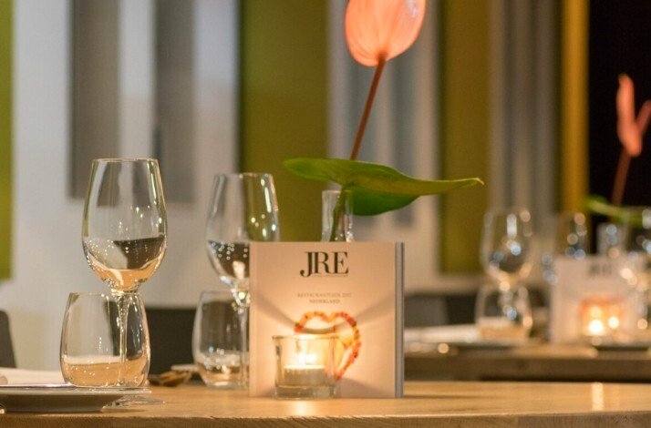 A served table with JRE label card lit buy the candle light.