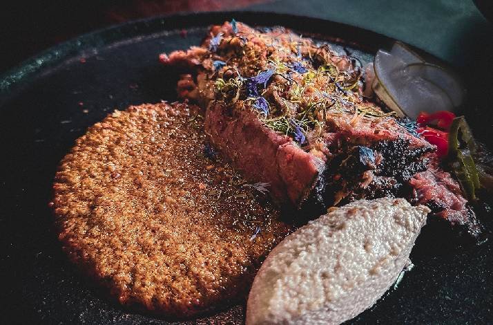 A plate of specialty smoked meats served as part of an omakase dinner at Blue Smoke by 1925.