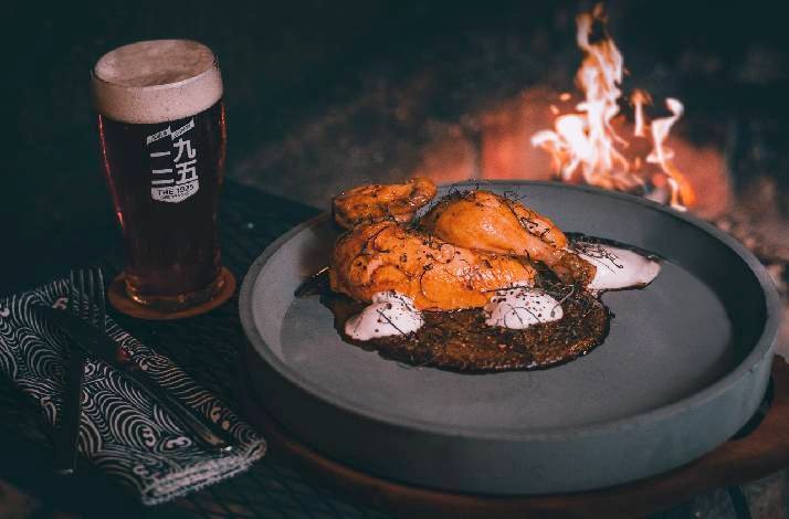 A dish served at Blue Smoke accompanied by a pint of craft beer in Singapore.