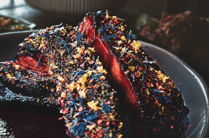 Close-up view of a meat dish, part of the omakase dinner served at Blue Smoke by 1925.